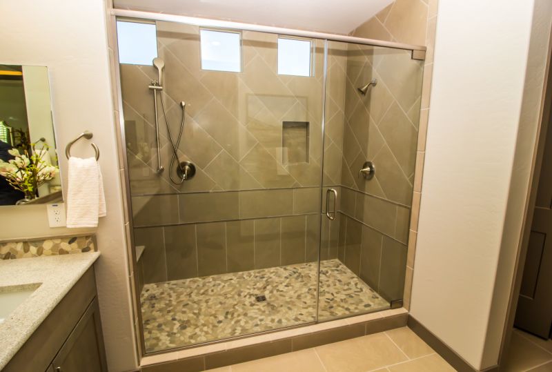 Modern bathroom renovation with glass shower enclosure